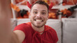 © Krakenimages.com - Young caucasian man wearing devil costume taking selfie picture at home