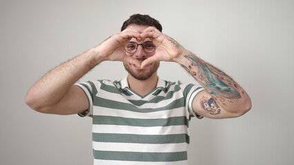 Poster - Young caucasian man smiling confident doing heart gesture with hands on face over isolated white background