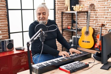 Poster - Middle age grey-haired man musician singing song playing piano at music studio