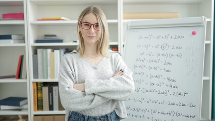 Wall Mural - Young blonde woman standing by magnetic board at library university