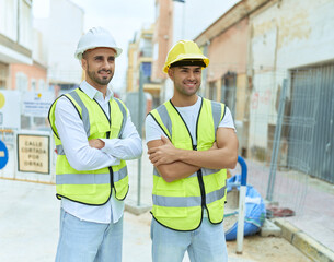 Wall Mural - Two hispanic men architects smiling confident standing with arms crossed gesture at street