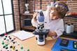 © Krakenimages.com - Adorable caucasian boy student using microscope at classroom