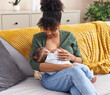 © Krakenimages.com - Mother and son sitting on sofa breastfeeding at home