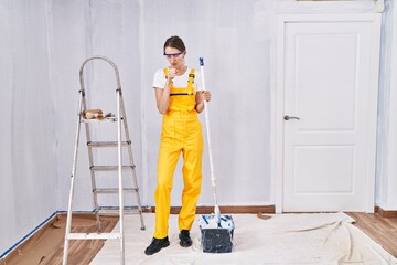 Wall Mural - Young caucasian woman painting walls feeling unwell and coughing as symptom for cold or bronchitis. health care concept.