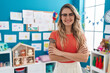 © Krakenimages.com - Young blonde woman teacher smiling confident standing with arms crossed gesture at kindergarten