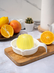 Manual plastic juicer on the kitchen table. We make freshly squeezed juice and vitamins