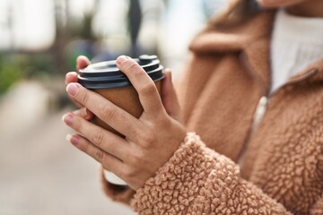 Poster - Young hispanic woman drinking coffee at street