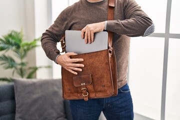 Sticker - Young caucasian man business worker holding laptop of briefcase at office