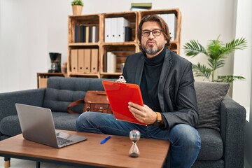 Poster - Handsome middle age man working at consultation office looking at the camera blowing a kiss on air being lovely and sexy. love expression.