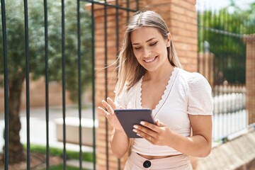 Sticker - Young caucasian woman smiling confident using touchpad at street