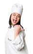 Young caucasian cook woman isolated points with thumb finger away, laughing and carefree.