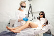 © Богдан Маліцький - leg epilation procedure in cosmetology clinic, cosmetologist makes depilation with alexandrite laser