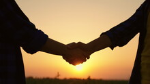 Business People Shake Hands With Each Other Outdoors In Field. Agriculture Business, Agricultural Industry. Farmers Men Women Greet Each Other With Their Hands, Work Together. Silhouette Of Farmers