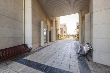 Wall Mural - Passageway with wooden benches of an urban residential housing estate