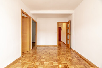 empty living room of an apartment with parquet flooring of freshly stabbed and varnished oak slats a
