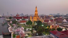 Aerial View Of Wat Arun Temple In Bangkok, Capital Of Thailand, Illuminated Traditional Thai Buddhist Temple Of War Arun At Sunset