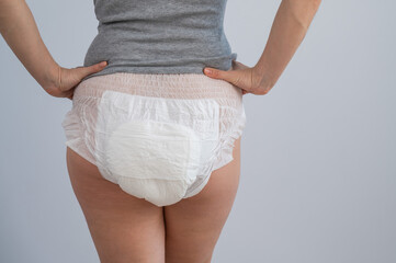 Wall Mural - Rear view of a woman in adult diapers. Incontinence problem.