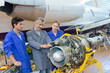 © auremar - aviation technician studying a part