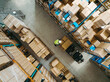 © Jacob Lund - Aerial view of a logistics worker placing goods onto a forklift