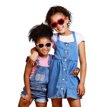 A Portrait Two Mixed Race Girl Sisters Wearing Funky Sunglasses. Happy And Carefree Kids Imagining Being Fashion Models Isolated On A Png Background.