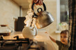 © Westend61 - Man pouring hot water in tea pot