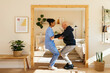 © Westend61 - Home caregiver assisting senior man in exercising at home