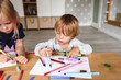 © Cavan Images - Little boy with sister drawing with felt-tip pens