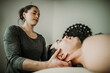 © Cavan Images - male massage patient has neck worked on by female massage therapist