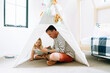 © Cavan Images - Closeup portrait of a dad and child reading together in a child's room
