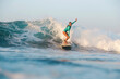 © Cavan Images - Female surfer on the wave