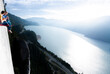 © Cavan Images - Two men laughing and smiling while drinking beer sunset on portaledge