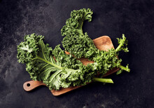 Studio Shot Of Fresh Kale (Brassica Oleracea)on Cutting Board