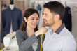 © auremar - beautiful female tailor is measuring her male client