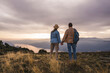 © Westend61 - Mature couple holding hands standing on mountain