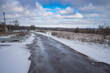 Winter landscape with country road covered with snow leading to Mishurin rog village, Dniproperovsk oblast, Ukraine