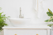 © didecs - Hand washing vessel sink on vintage wooden countertop in bathroom