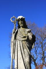 Poster - A statue of an older Jesus Christ holding a lamb.