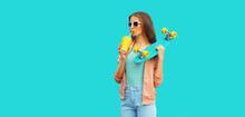 Portrait Of Stylish Young Woman With Skateboard Drinking Juice On Blue Background