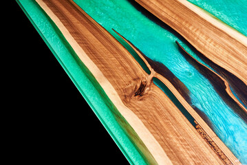 Wall Mural - Texture of a wooden table with epoxy resin isolated on black