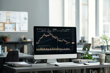 Fototapete - Financial graph and chart on screen of desktop computer standing on workplace of economist or stock exchange analyst