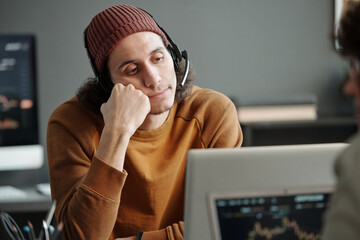 Aufkleber - Young bored operator of call center sitting in front of laptop screen and listening to description of problem of online client of helpdesk