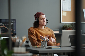 Aufkleber - Young confident businessman with headset communicating with online clients and offering them help with solving technical problems