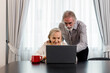 © butsaya33 - Happy Caucasian 70s mature couple using laptop at home. Old people using computer at home. Senior man and woman surfing the web on a wireless laptop connection. Modern retired lifestyle people.