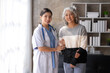 © amnaj - Asian female doctor or nurse gently guide and care for elderly patient at home, giving warm encouragement and consolation.