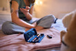 © Monkey Business - Close Up Of Young Diabetic Girl Sitting On Bed In Bedroom At Home Using Kit To Check Insulin Levels