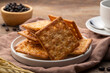 © Kritchai - Dry thin crispy sugar crackers in white plate on wooden table