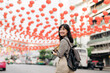 © Jirawatfoto - Young Asian woman backpack traveler enjoying China town street food market in Bangkok, Thailand.