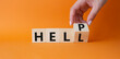 © Natallia - Help vs Hell symbol. Businessman hand Turnes cube and changes word Hell to Help. Beautiful orange background. Psychology and Help vs Hell concept. Copy space