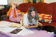 © Solid photos - Young serious woman student studying for exams at home