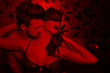 Passionate couple foreplay at night in red light kissing neck